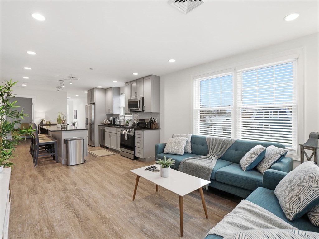 149 Pleasant Street, Unit 2 Marblehead, MA 01945 - Photo 4 of 41 a living room with furniture and a large window