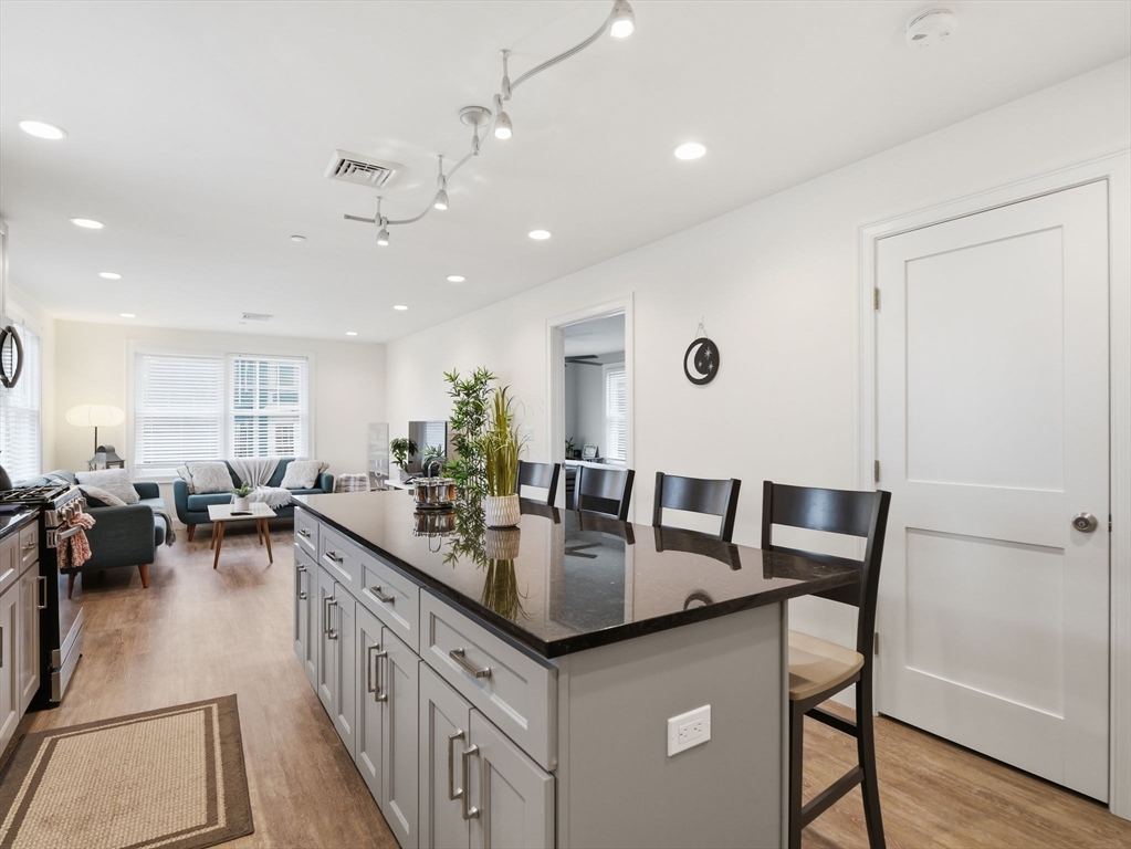 149 Pleasant Street, Unit 2 Marblehead, MA 01945 - Photo 9 of 41 a kitchen with counter space dining table and chairs
