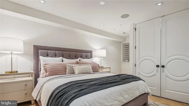 a bedroom with a bed and painting on the wall