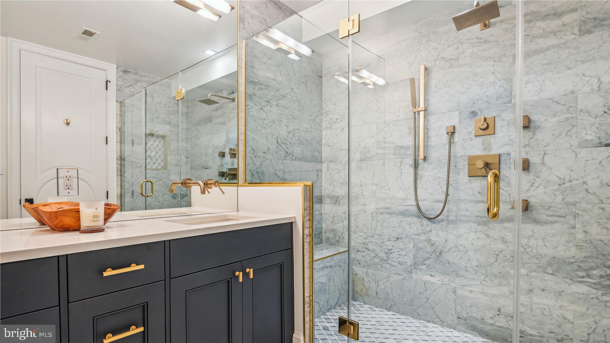 1832 16th Street Northwest, Unit 1 Washington, DC 20009 - Photo 16 of 25 a bathroom with a double vanity sink mirror and shower