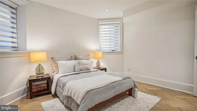 a bedroom with a bed and a night stand