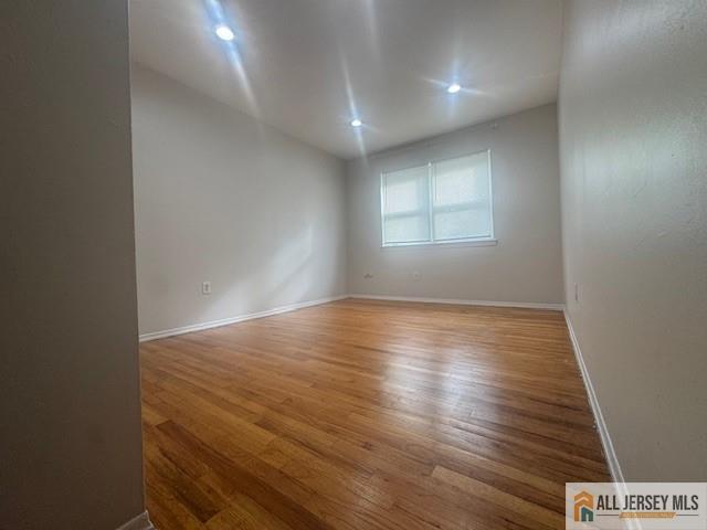 37 Judson Street Edison, NJ 08837 - Photo 7 of 11 an empty room with wooden floor and windows