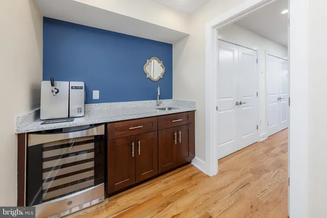 a spacious bathroom with a granite countertop sink and a mirror