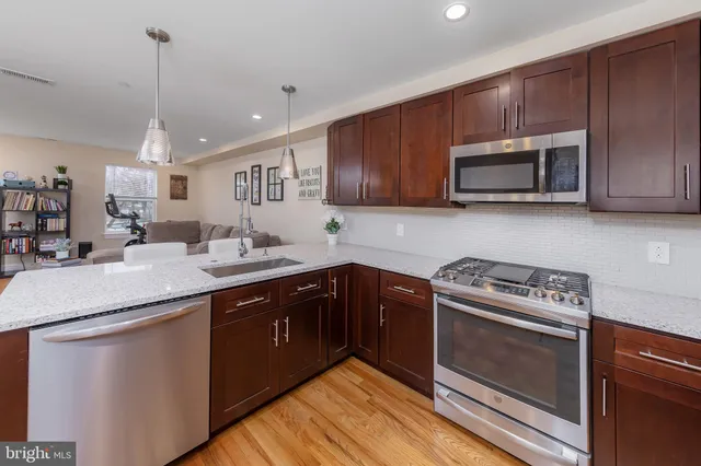 a kitchen with sink cabinets and stainless steel appliances