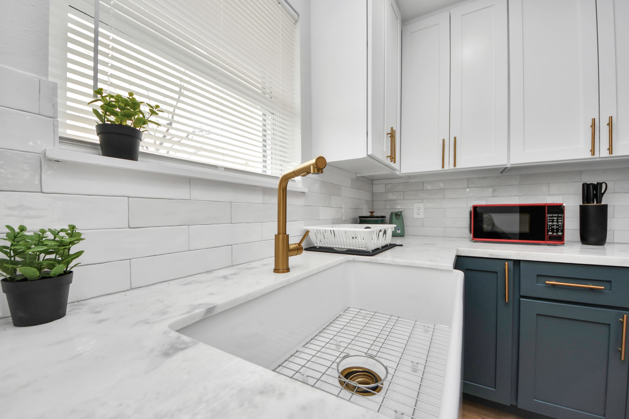 5115 Clay Street Houston, TX 77023 - Photo 17 of 43 a kitchen with a sink a stove and cabinets