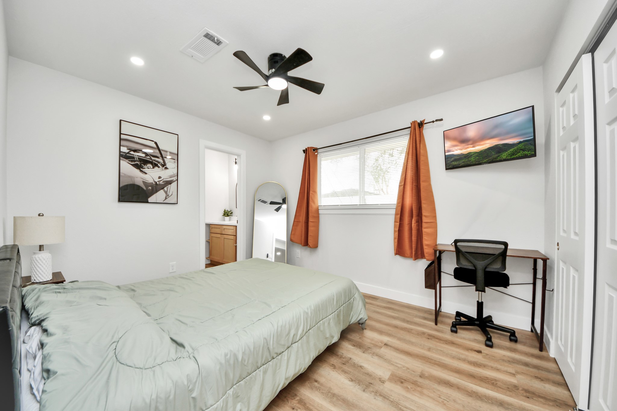 5115 Clay Street Houston, TX 77023 - Photo 28 of 43 a bedroom with a bed and a chandelier