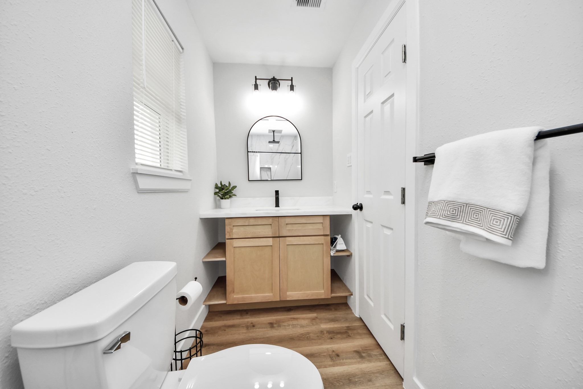 5115 Clay Street Houston, TX 77023 - Photo 30 of 43 a bathroom with a toilet sink and mirror
