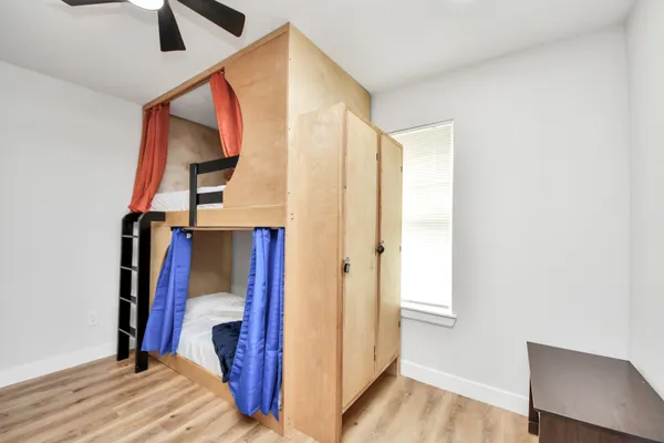 a view of bedroom with a bed and a potted plant