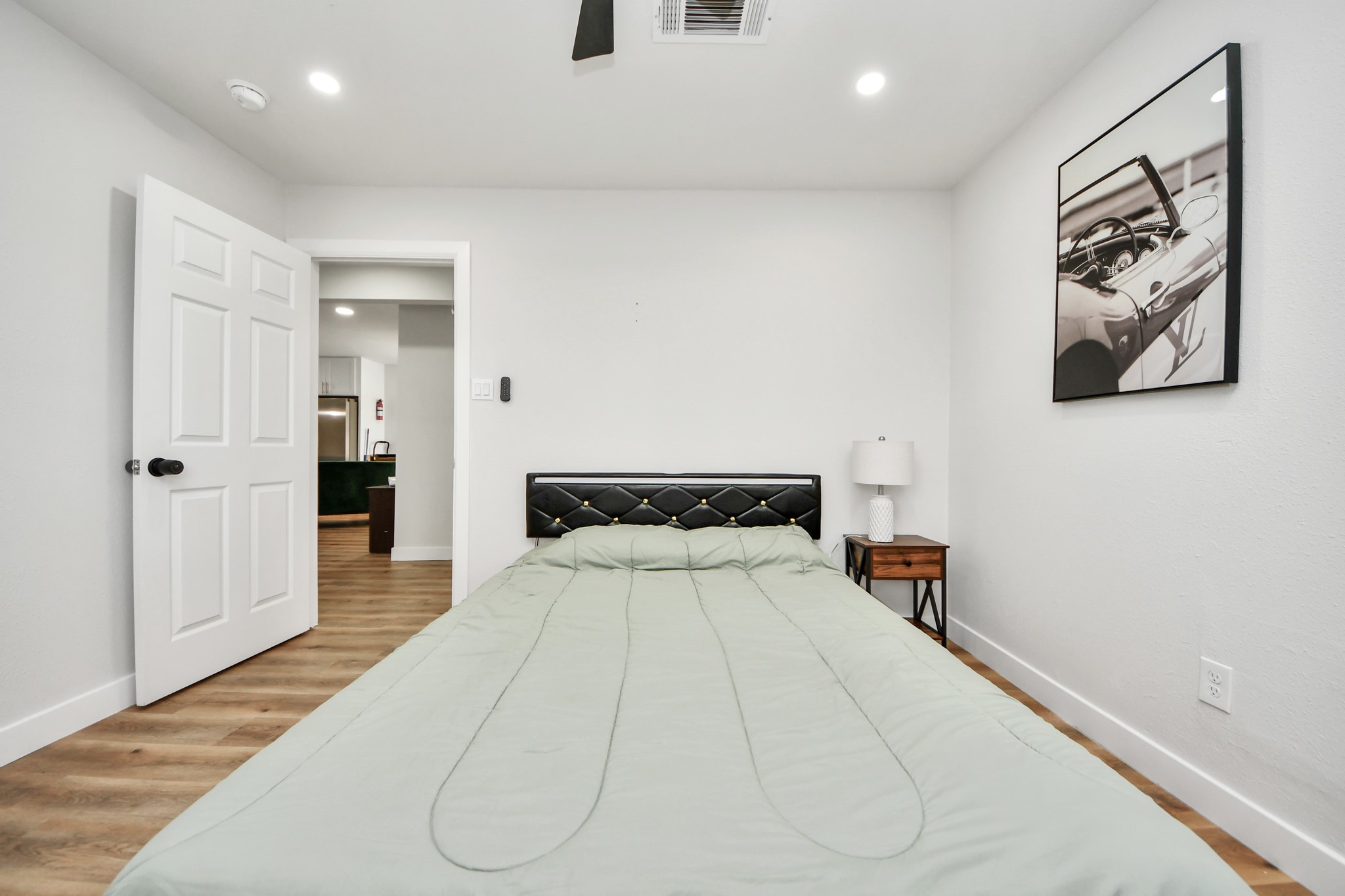 5115 Clay Street Houston, TX 77023 - Photo 31 of 43 a bedroom with a bed and a painting on the wall