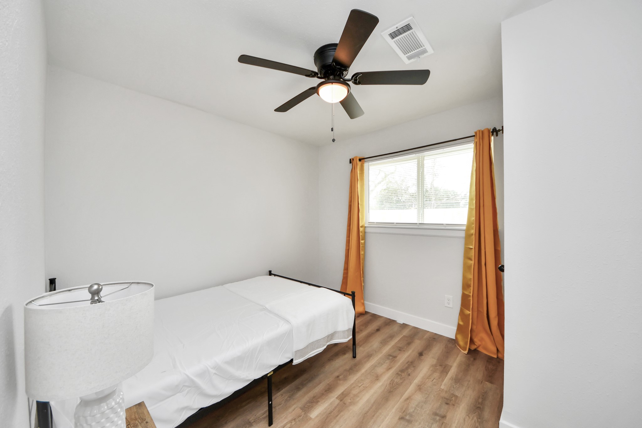 5115 Clay Street Houston, TX 77023 - Photo 32 of 43 a bed room with a bed and a window