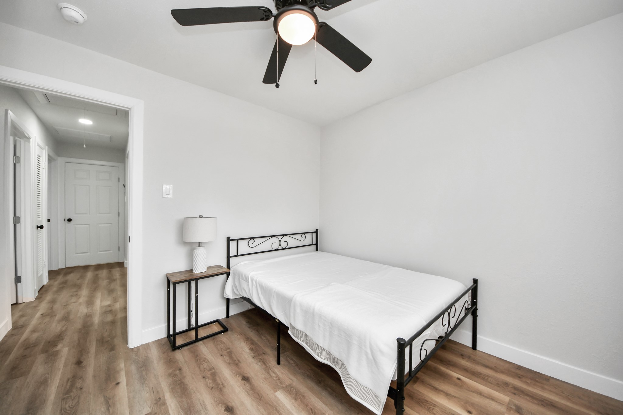 5115 Clay Street Houston, TX 77023 - Photo 34 of 43 a bedroom with a bed and a chandelier