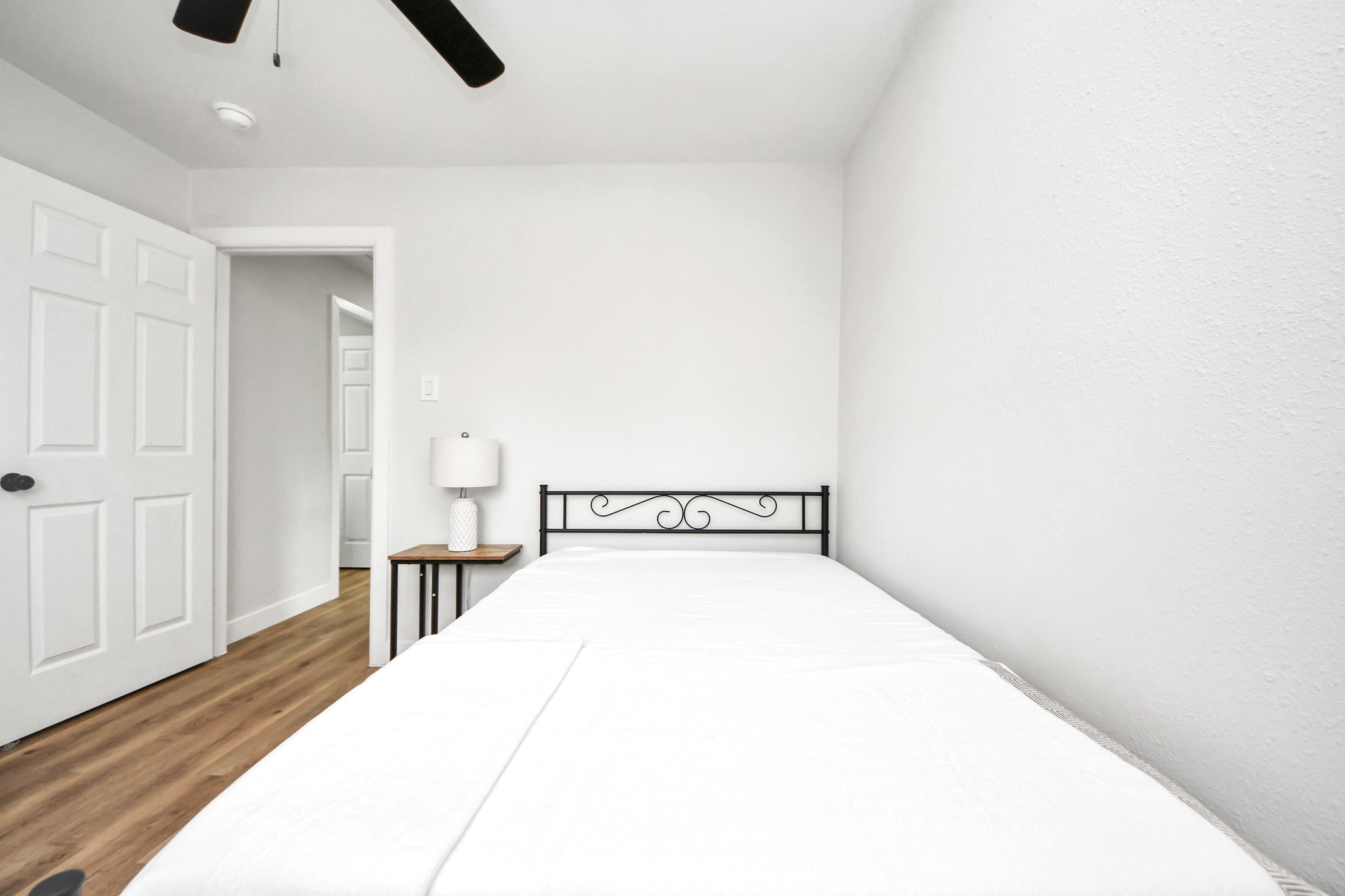 5115 Clay Street Houston, TX 77023 - Photo 35 of 43 a view of a bedroom with a bed and wooden floor