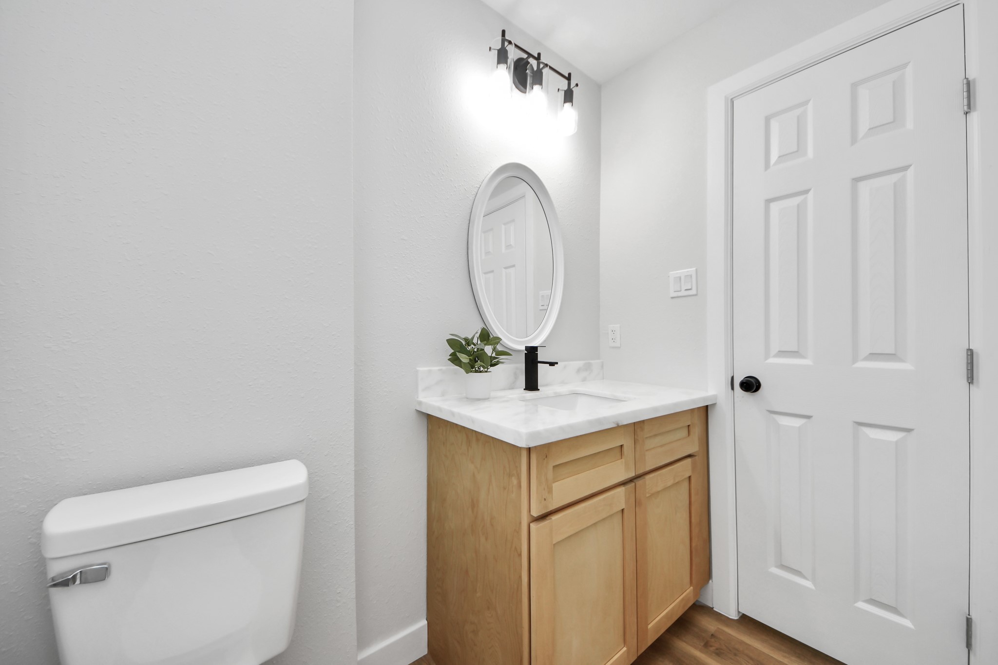 5115 Clay Street Houston, TX 77023 - Photo 36 of 43 a bathroom with a toilet a sink and a mirror