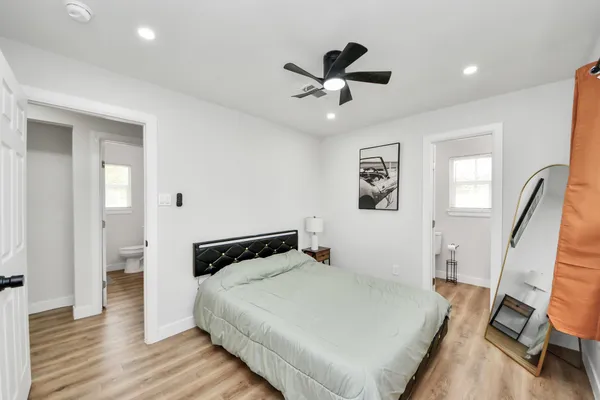 a bedroom with a bed and wooden floor