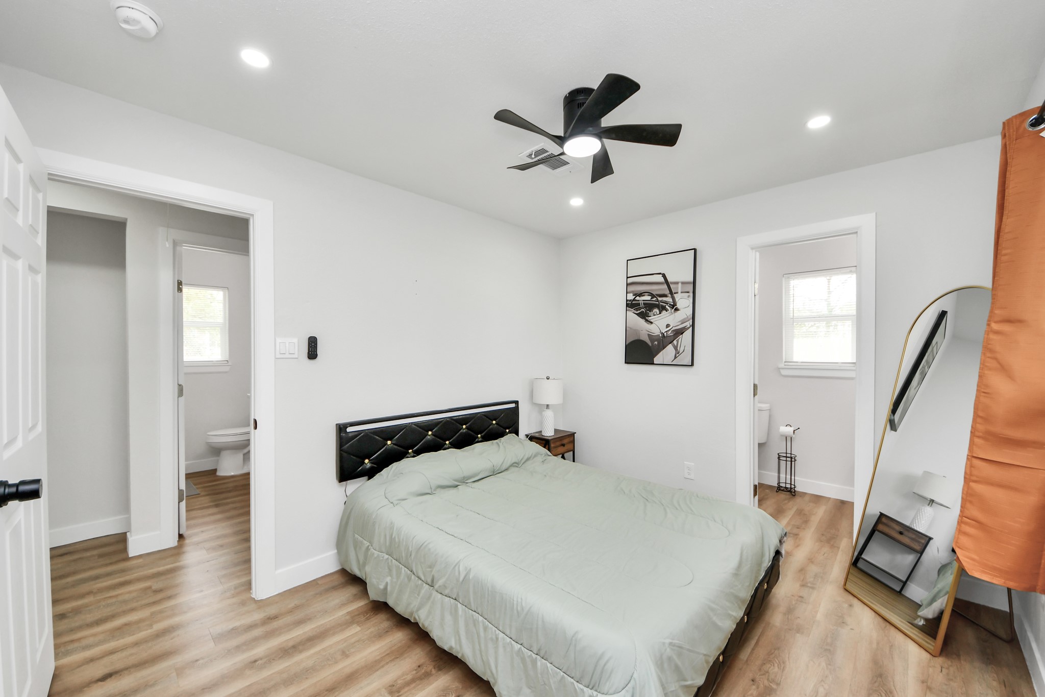 5115 Clay Street Houston, TX 77023 - Photo 4 of 43 a bedroom with a bed and wooden floor