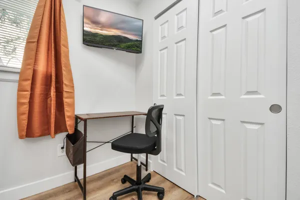 a view of a room with furniture and wooden floor