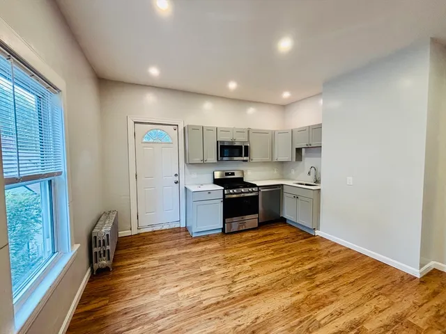 a kitchen with stainless steel appliances granite countertop a refrigerator and a stove top oven