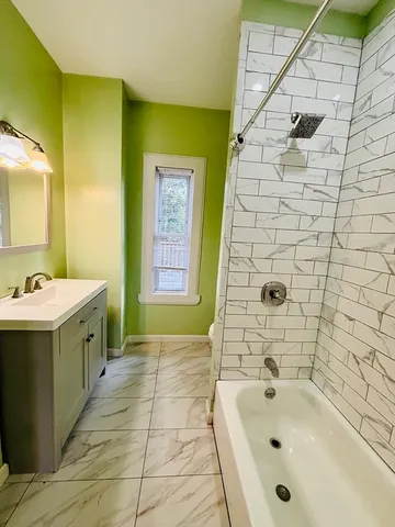 a view of a room with wooden floor and window