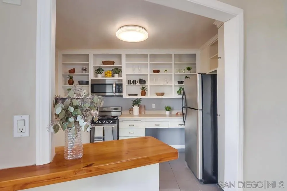 2701 2nd Avenue, Unit 201 San Diego, CA 92103 - Photo 17 of 39 a kitchen with stainless steel appliances granite countertop a refrigerator and a stove top oven