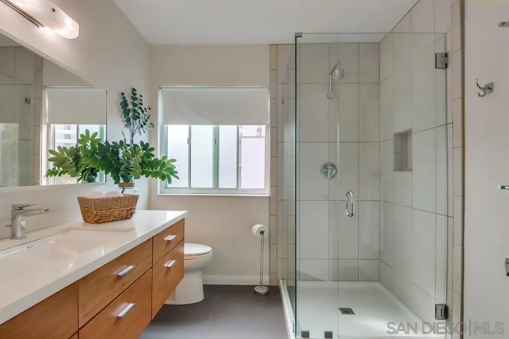 2701 2nd Avenue, Unit 201 San Diego, CA 92103 - Photo 33 of 39 a bathroom with a shower sink mirror and toilet
