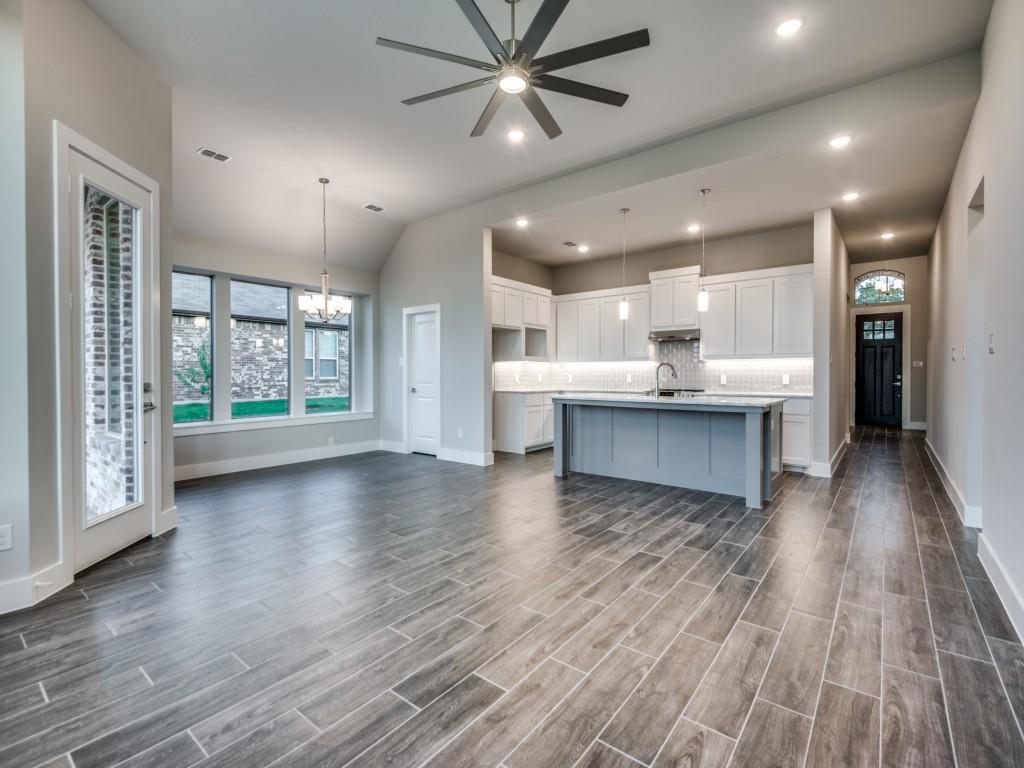 139 Lakeview Circle Pilot Point, TX 76258 - Photo 18 of 19 Kitchen with open floor plan, white cabinetry, and decorative backsplash