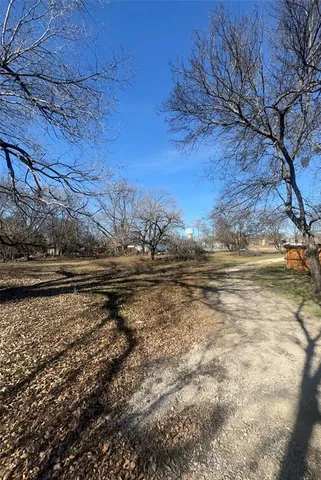 a view of a yard with wooden house