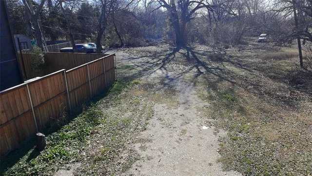 a view of a pathway with a wrought fence