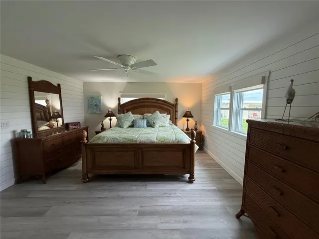 a spacious bedroom with a bed and a dresser