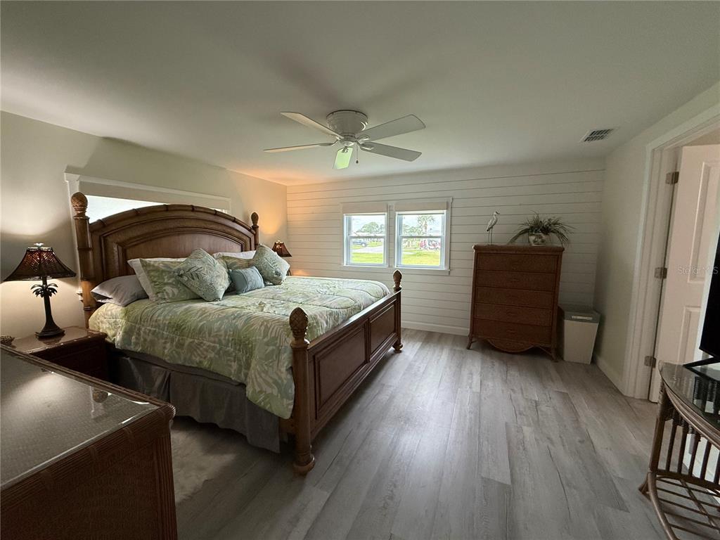 637 Los Altos, Unit 374 North Port, FL 34287 - Photo 12 of 26 a spacious bedroom with a bed and a dresser in it