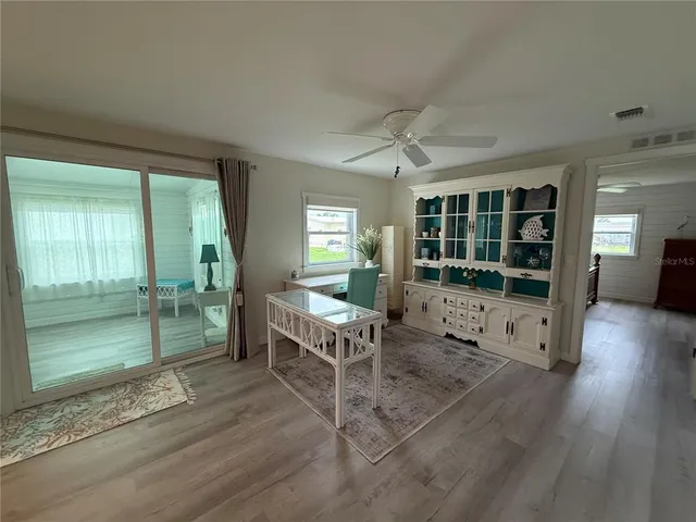 a living room with furniture window and wooden floor