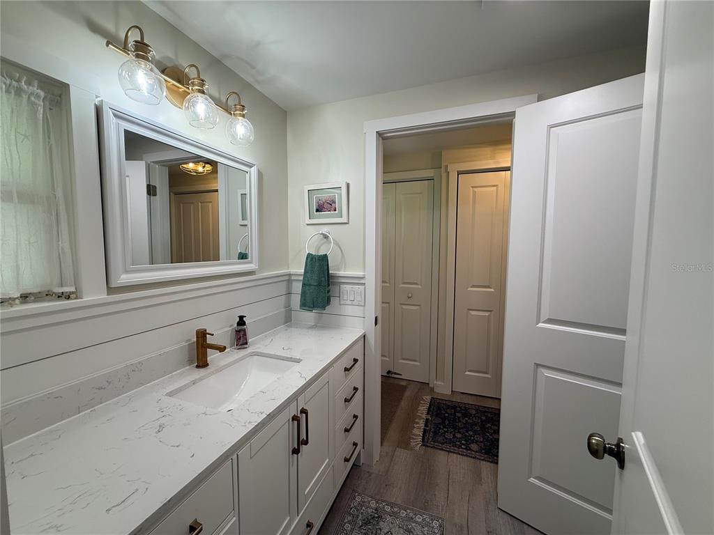 637 Los Altos, Unit 374 North Port, FL 34287 - Photo 16 of 26 a bathroom with a granite countertop sink and a mirror