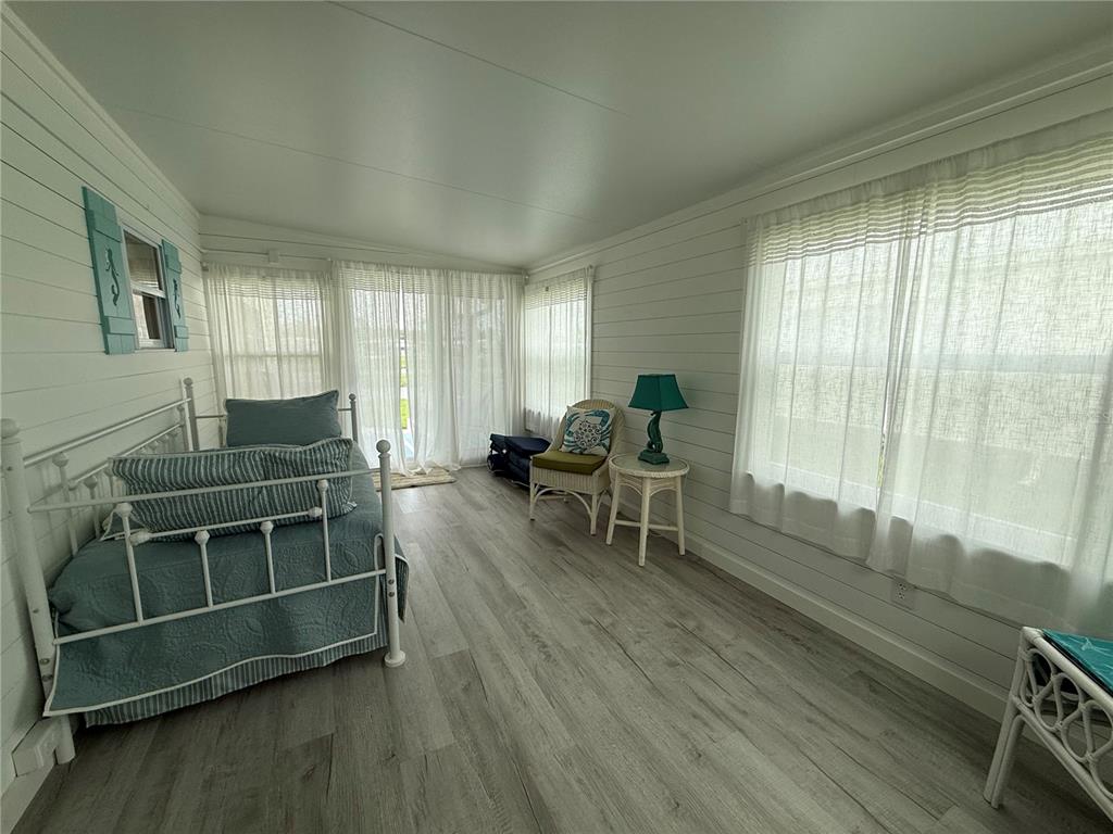 637 Los Altos, Unit 374 North Port, FL 34287 - Photo 18 of 26 a living room with furniture a flat screen tv and wooden floor