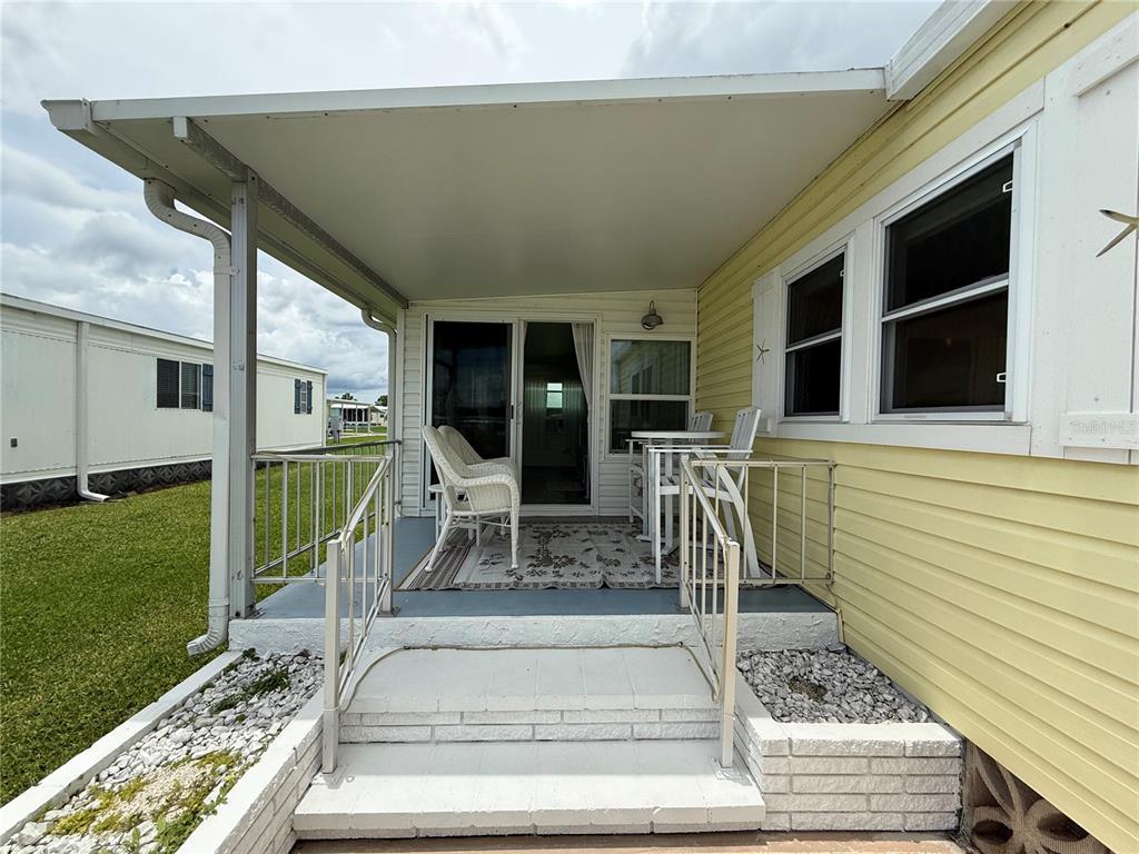 637 Los Altos, Unit 374 North Port, FL 34287 - Photo 21 of 26 a view of a house with backyard and porch