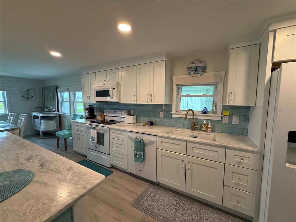 637 Los Altos, Unit 374 North Port, FL 34287 - Photo 4 of 26 a kitchen with white cabinets and sink