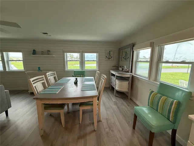 a view of a dining room with furniture and a large window