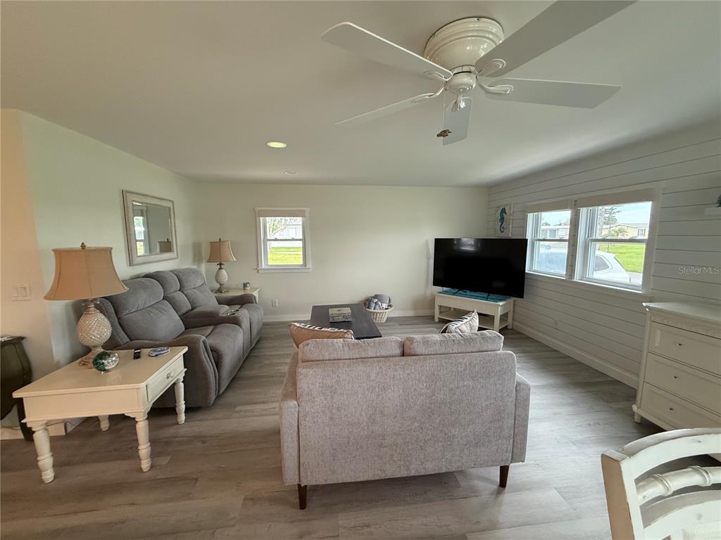 637 Los Altos, Unit 374 North Port, FL 34287 - Photo 7 of 26 a living room with furniture and a flat screen tv