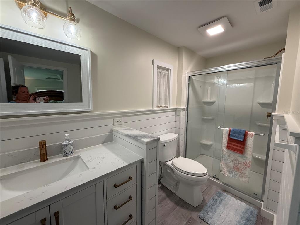 637 Los Altos, Unit 374 North Port, FL 34287 - Photo 9 of 26 a bathroom with a sink a toilet a mirror and shower