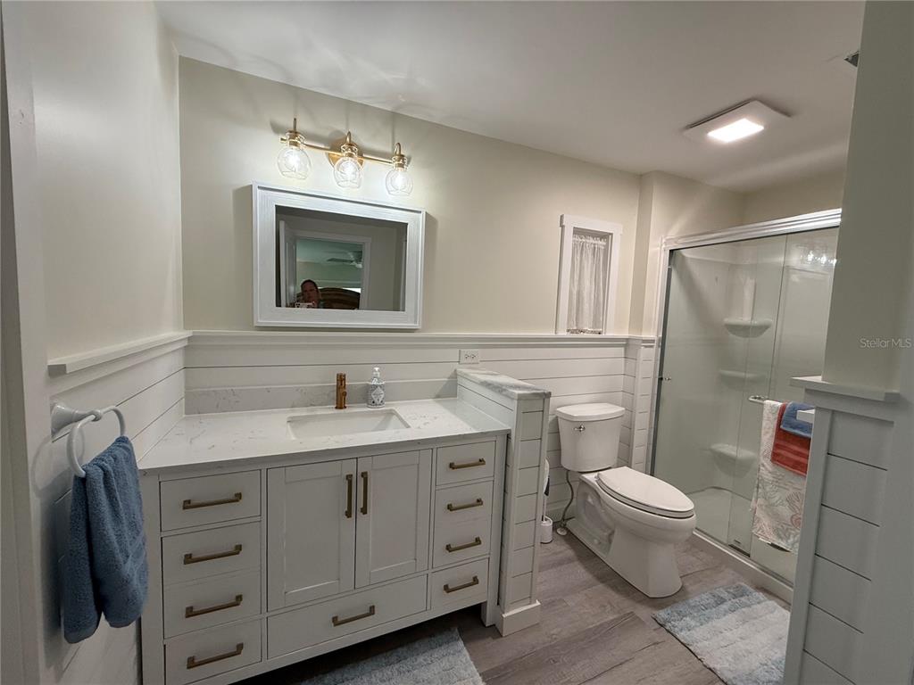 637 Los Altos, Unit 374 North Port, FL 34287 - Photo 10 of 26 a bathroom with a granite countertop toilet sink and mirror