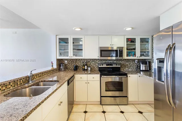 a kitchen with a stove a sink and a refrigerator