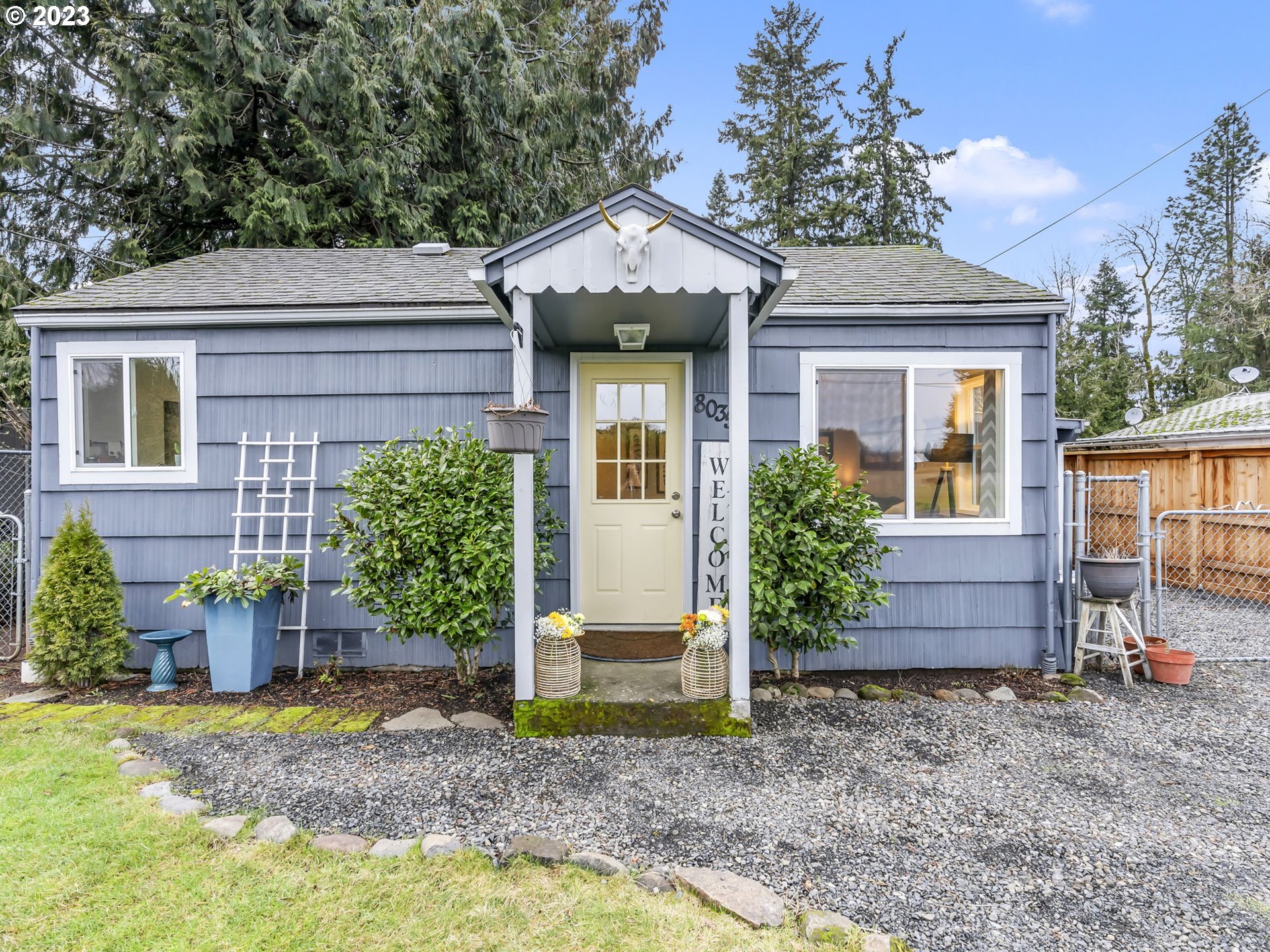 8035 Southeast Pleasant Home Road Gresham, OR 97080 - Photo 1 of 27 a front view of a house with garden