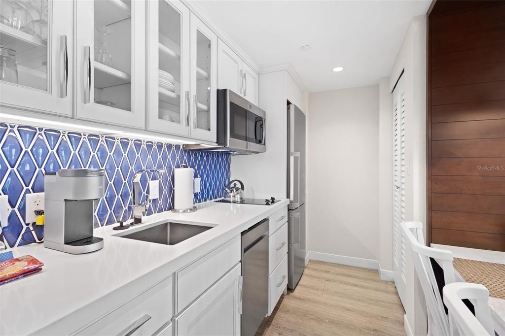 240 Sands Point Road, Unit 4104 Longboat Key, FL 34228 - Photo 15 of 47 a kitchen with a sink and a refrigerator