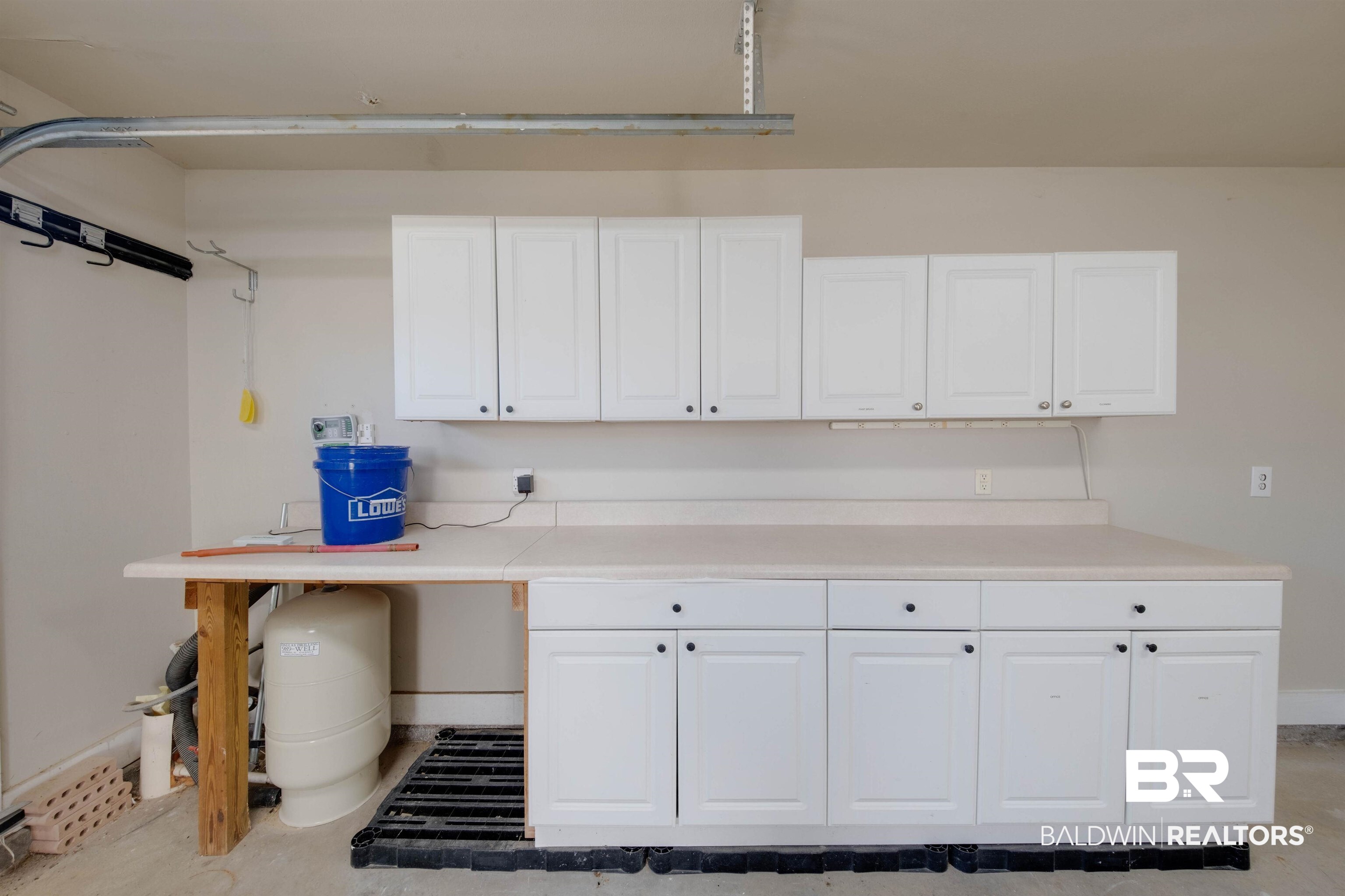 9462 Lakeview Drive Foley, AL 36535 - Photo 26 of 50 Garage featuring white cabinetry. Irrigation pump.