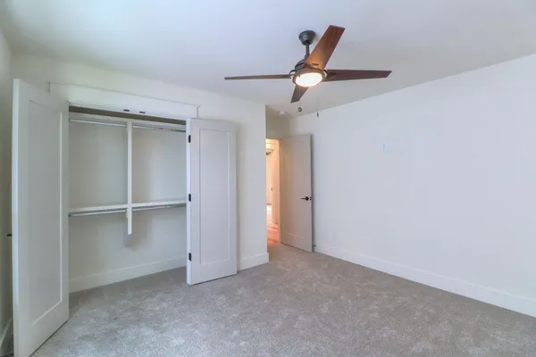an empty room with closet and window