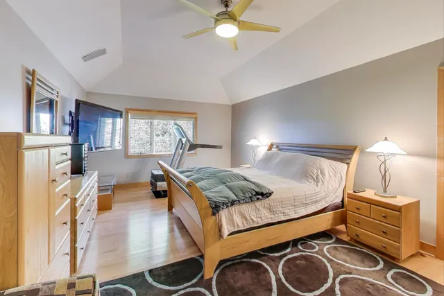 a bedroom with furniture and a chandelier