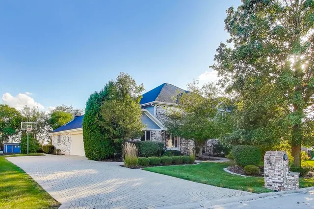 a front view of a house with a yard and a garage