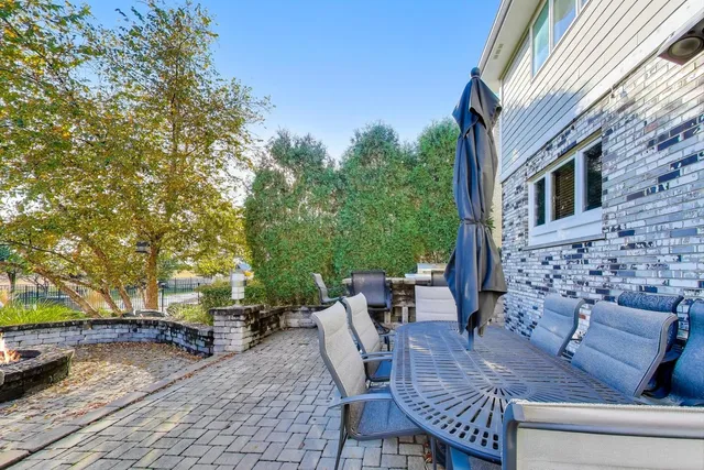 a view of a patio with table and chairs and potted plants