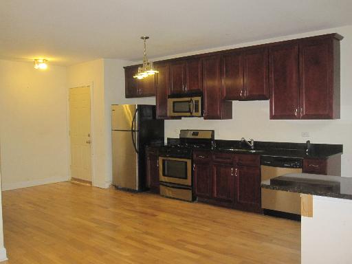 4540 West George Street, Unit 1 Chicago, IL 60641 - Photo 5 of 10 a kitchen with stainless steel appliances granite countertop a stove and a refrigerator