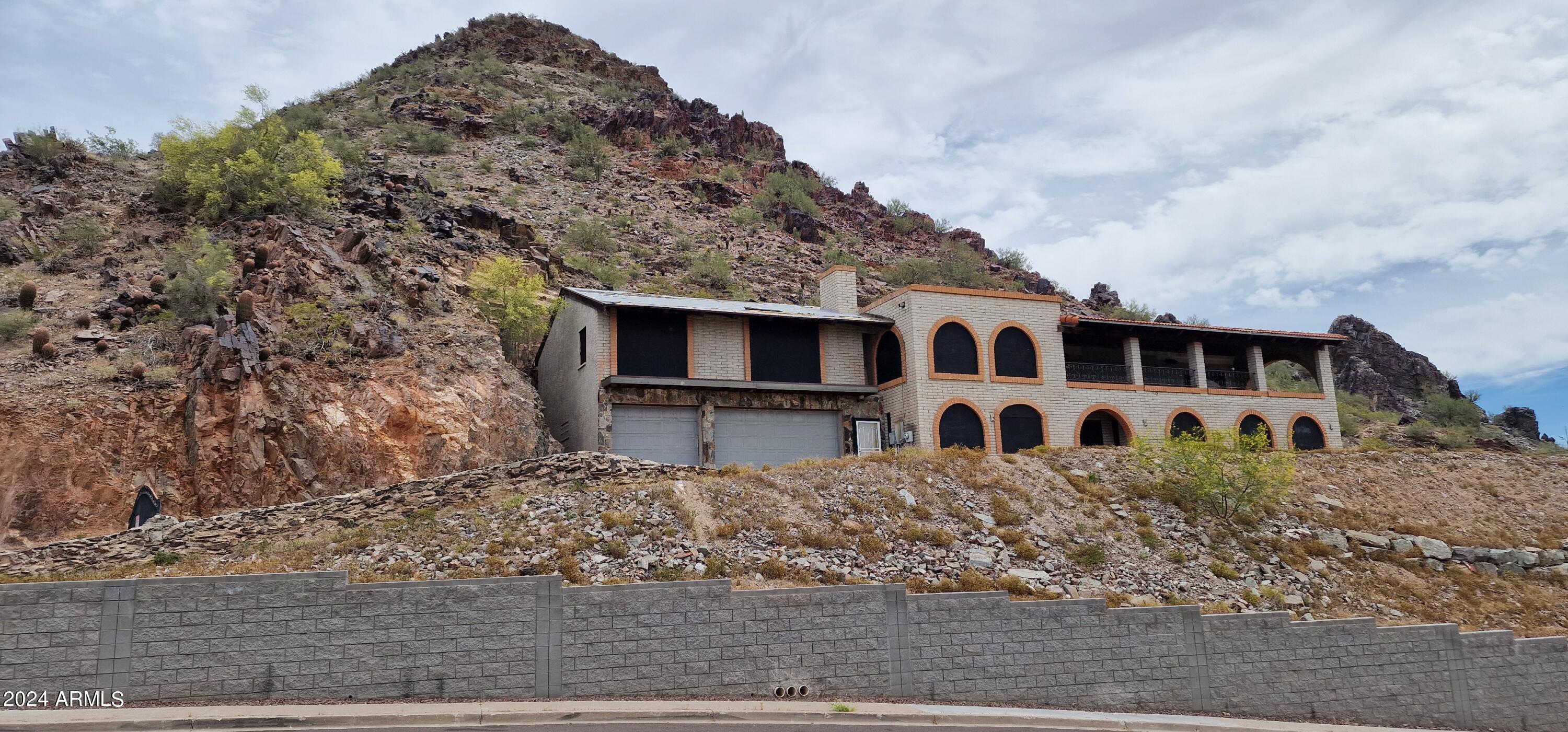 7035 North 23rd Place Phoenix, AZ 85016 - Photo 8 of 10 a big house with large trees and wooden fence