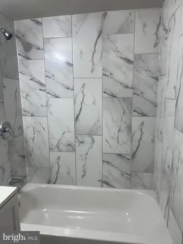 a bathroom with a bathtub and shower