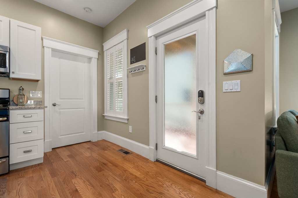 19 Pinckney Street, Unit 1 Somerville, MA 02145 - Photo 11 of 39 a view of a kitchen with wooden floor and cabinets